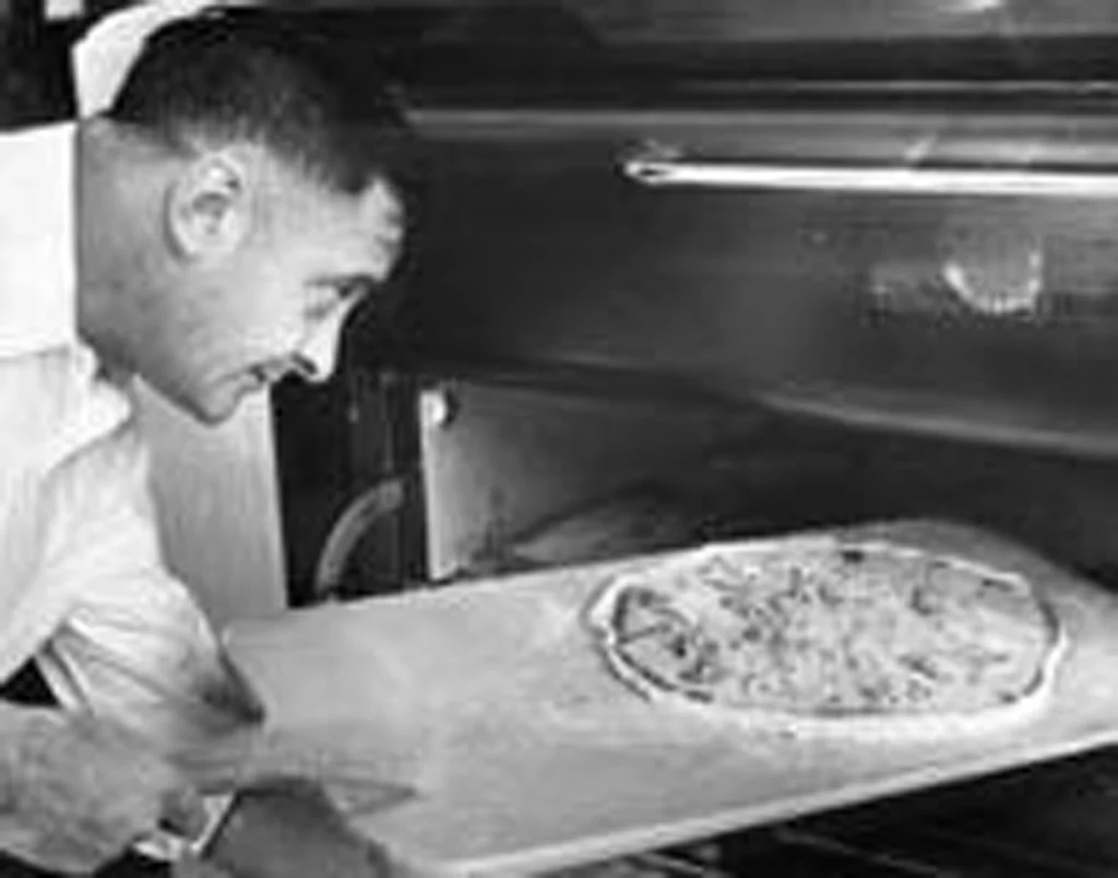 Archival photograph of Sam Perrella inside the original cafe